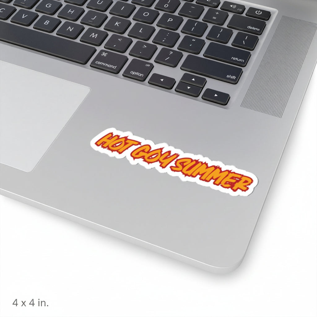 A die-cut vinyl sticker with the text 'HOT GOY SUMMER' in orange and yellow bubbly lettering with a white outline, shown applied to the silver palm rest of a laptop keyboard.